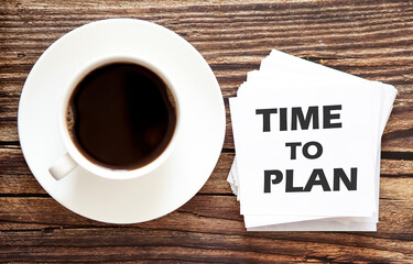 Business TIME TO PLAN . White stickers with text on the wooden background with coffee