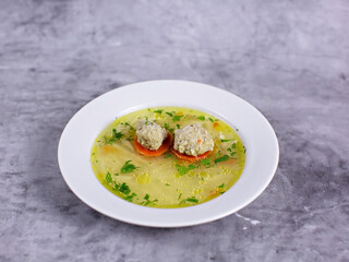 Soup with meatballs and greens