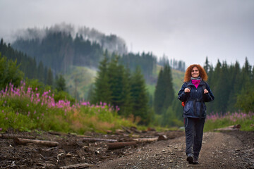 Backpacker with raincoat hiking