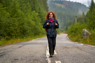 Backpacker with raincoat hiking