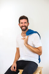 Model with blue eyes and blue t shirt looking at camera.