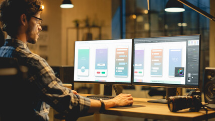 Late Evening Creative Office: Professional Programmer Works on a Desktop Computer, Creating Phone...