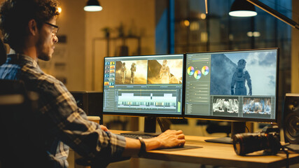 Late Evening Creative Office: Professional Videographer Works on Desktop Computer, Doing Footage...