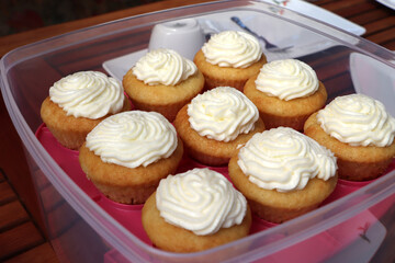 Delicious homemade muffins with cream. Cupcakes. Close up.