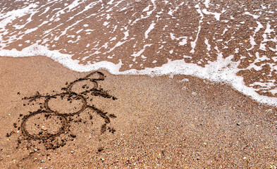 Fototapeta na wymiar image of a snowman on the sea sand