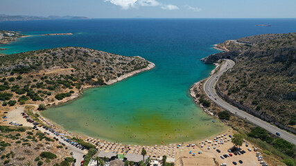 Fototapeta na wymiar Aerial drone photo of small protected by winds cove and sandy beach of Lomvarda in Athens riviera next to Hole of Karamanlis tunnel, Vouliagmeni, Attica, Greece