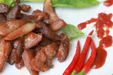 Fried pork and red chili on plate