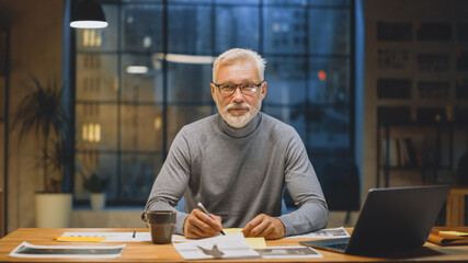 Portrait of the Handsome and Successful Middle Aged Bearded Businessman Working at His Desk Using...