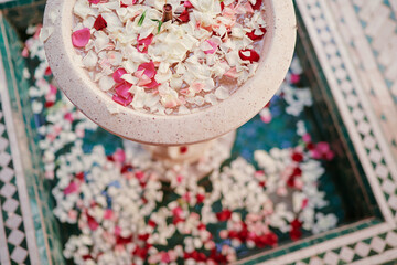 Fountain bowl with roses petals.
