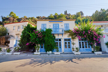 Traditional white houses Aegean architecture. Beautiful cityscape with red tiled roofs of  Poros town, Greece.