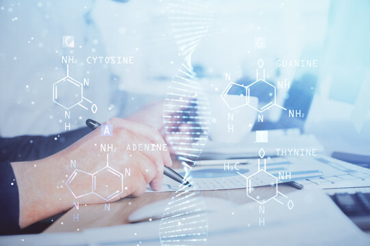 Man's hands working with notes background. Genetic engineering and gene manipulation concept.