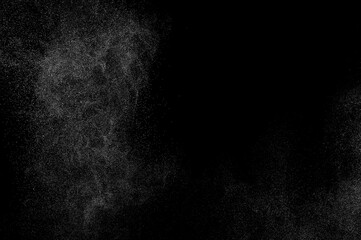 Abstract splashes of water on black background. Freeze motion of white particles. Rain, snow overlay texture.