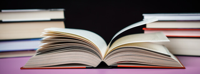 Banner open book on the table. It is time for education and therefore you need to go back to school.
