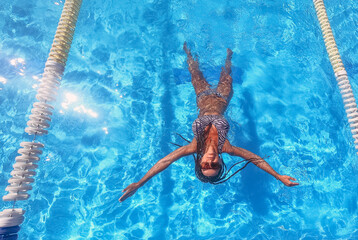 Swimming pool. Woman in a swimsuit swims in the pool.