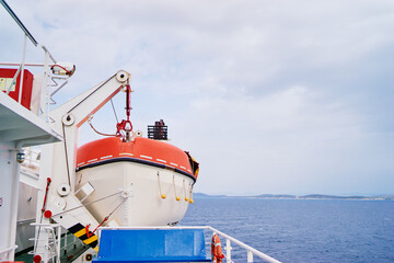Transportation and safety. Lifeboat on ferry deck.