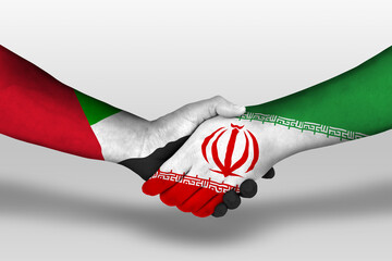 Handshake between iran and united arab emirates flags painted on hands, illustration with clipping...