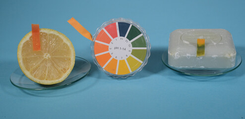 Universal indicator paper for pH value is shown in use on a lemon with a pH value of approx. 2, and a piece of hand soap with a pH value of approx. 11