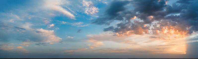 Naklejka na ściany i meble Panorama, cloudy sky at sunset. Pink clouds.