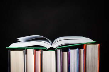 Naklejka premium Collection books on black background.