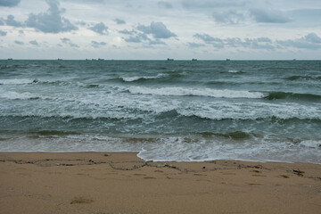 small wave on the dirty quiet beach in Thailand