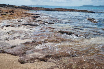 Sea waves and rock stones on the beach.