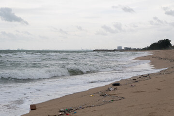 small wave on the dirty quiet beach in Thailand