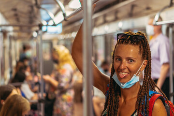 Medical mask. A woman in a medical mask rides on public transport.
