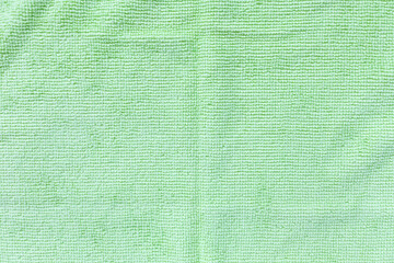 Green microfiber cloth for cleaning. Cleaning micro fabric towels for dusting and polishing. Domestic household cleaning service concept. Close up, copy space