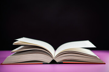 Open book on the table. It is time for education and therefore you need to go back to school.