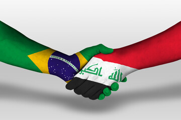 Handshake between iraq and brazil flags painted on hands, illustration with clipping path.