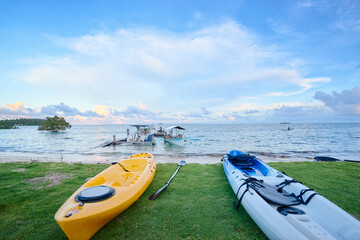 Colorful kayaks on the beach of island in Philippines. Tropical vacation and travel. Active tourism.