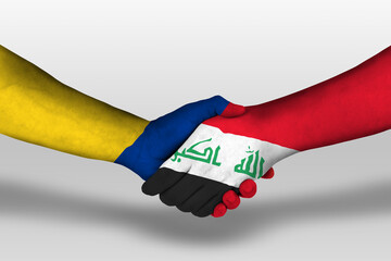 Handshake between iraq and columbia flags painted on hands, illustration with clipping path.