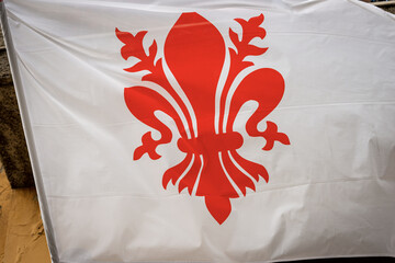 Closeup of a Florence city Flag, red lily on a white background. Tuscany, Italy, Europe
