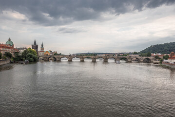 Charles Bridge (Karluv Most), as seen from  Manes Bridge, most famous historic sandstone bridge over Vltava river in Prague, most visited site in Prague, Czech Republic.