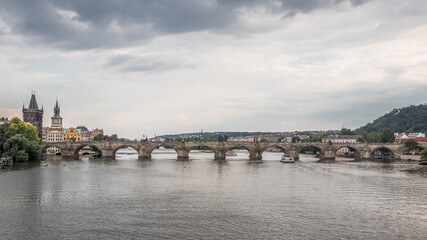 Fototapeta na wymiar Charles Bridge (Karluv Most), as seen from Manes Bridge, most famous historic sandstone bridge over Vltava river in Prague, most visited site in Prague, Czech Republic.