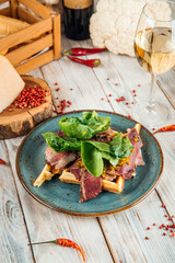 Belgian waffles with beef pastrami and greens
