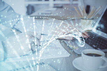 DNA hologram with businessman working on computer on background. Concept of bioengineering. Double exposure.