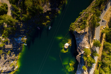 panoramic view of the green lake in the mountains in the canyon filmed from a drone