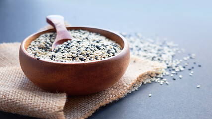 Organic natural sesame seeds wooden spoon. toasted sesame seeds. Raw, whole, unprocessed. Natural...