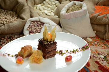 Fototapeta na wymiar turkish traditional dessert in front of legume family sacks