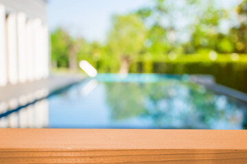 Product show On a brown wooden table Outdoor swimming pool area