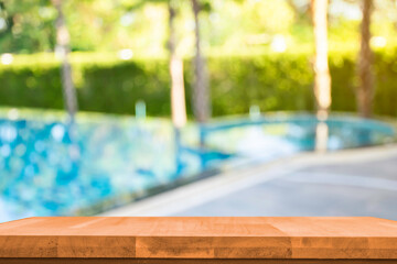 Product show On a brown wooden table Outdoor swimming pool area