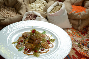 turkish traditional dessert in front of legume family sacks