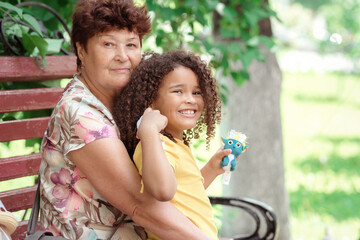 Smiling generations - portrait of grandmother with her daughter and grandchilld outdoor in nature.