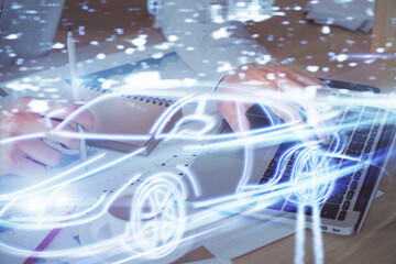 Obraz premium Automobile theme drawing with businessman working on computer on background. Autopilot taxi concept. Double exposure.