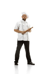 Cooker, chef, baker in uniform isolated on white studio background, gourmet. Young man, restaurant cooker's portrait. Business, foor, professional occupation, emotions concept. Copyspace for ad.