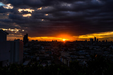 The high angle background of the city view with the secret light of the evening, blurring of night lights, showing the distribution of condominiums, dense homes in the capital community