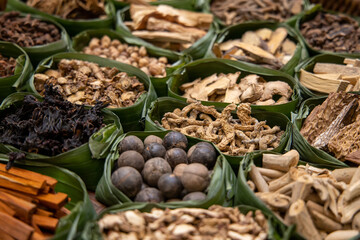Asian dried herbs for alternative medicine therapy. Dried medicinal herbs in banana leaf tray for sacrificial offering of god in asian or thai traditional worship. 