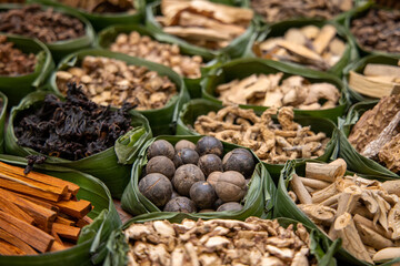 Asian dried herbs for alternative medicine therapy. Dried medicinal herbs in banana leaf tray for sacrificial offering of god in asian or thai traditional worship. 