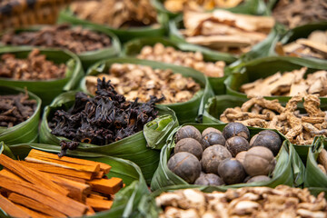 Asian dried herbs for alternative medicine therapy. Dried medicinal herbs in banana leaf tray for sacrificial offering of god in asian or thai traditional worship. 